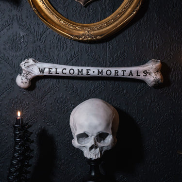 welcome mortals femur bone by The Blackened Teeth Ltd