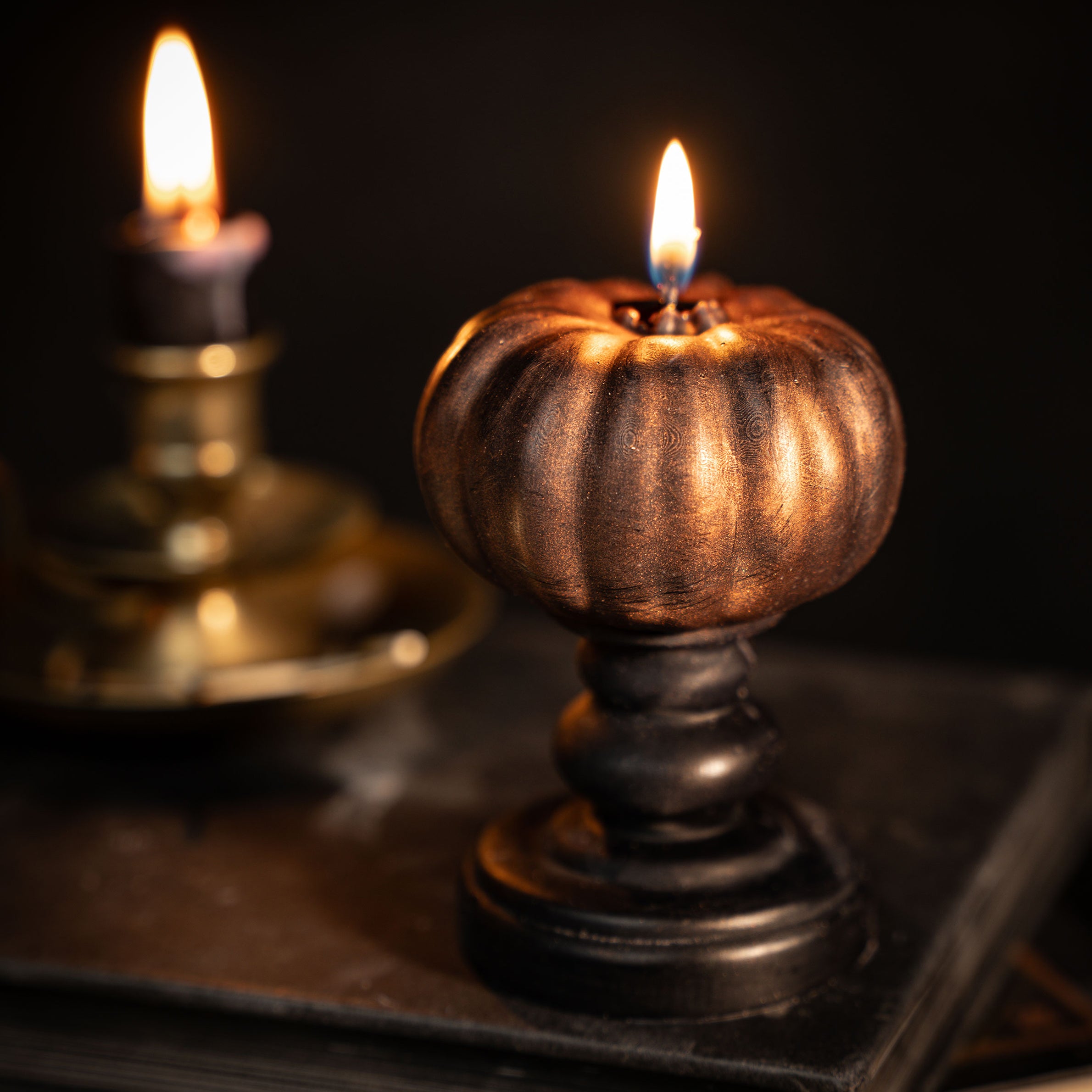 bronze pumpkin candle on black plinth by the blackened teeth gothic home decor