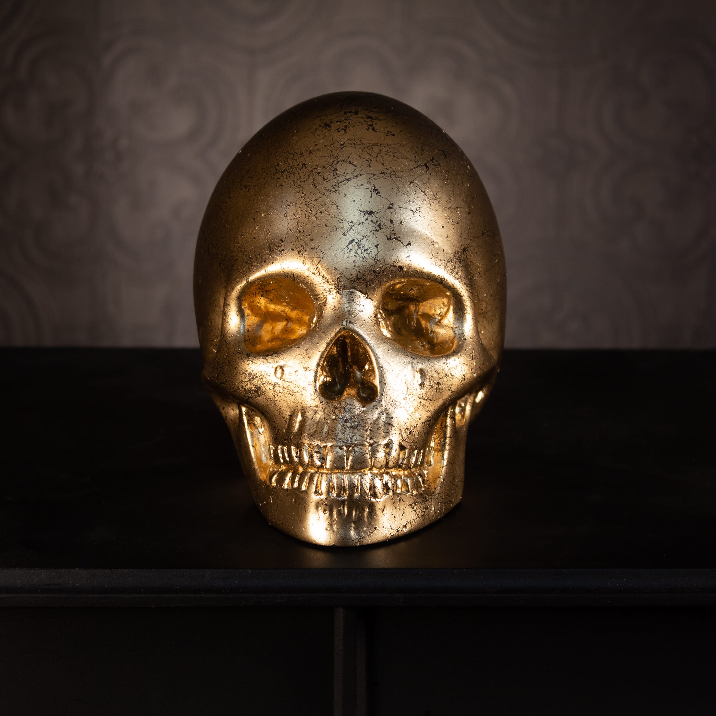 gold skull ornament black marble the blackened teeth